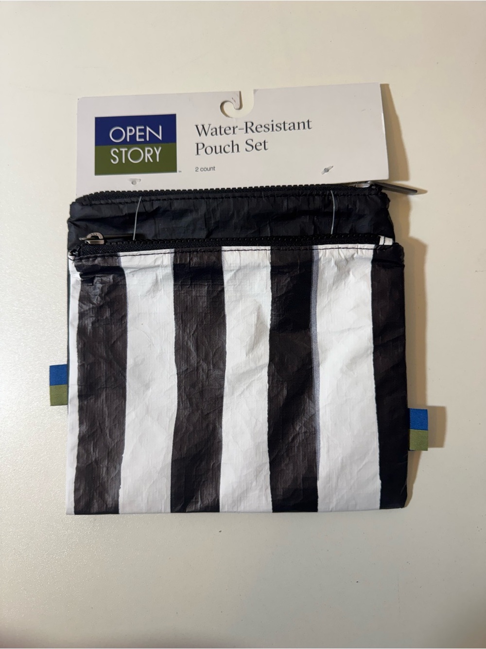 Black & White Striped and Black Water-Resistant Pouches